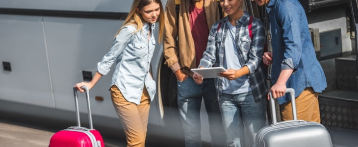 Four young people about to get on a charter bus